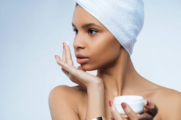 Pleasant beautiful woman holding a bottle with cream — Stock Photo, Image