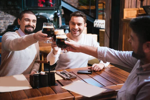 Cheerful happy men clinking their glasses — Stock Photo, Image