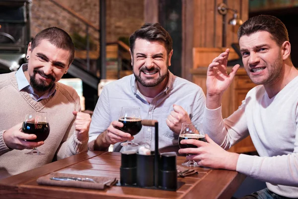 Positive joyful men supporting their football team — Stock Photo, Image