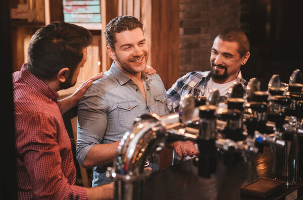 Positive handsome man enjoying their conversation