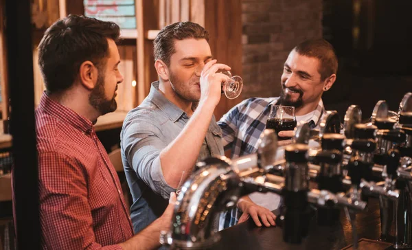 Joyful attractive man drinking beer — Stock Photo, Image