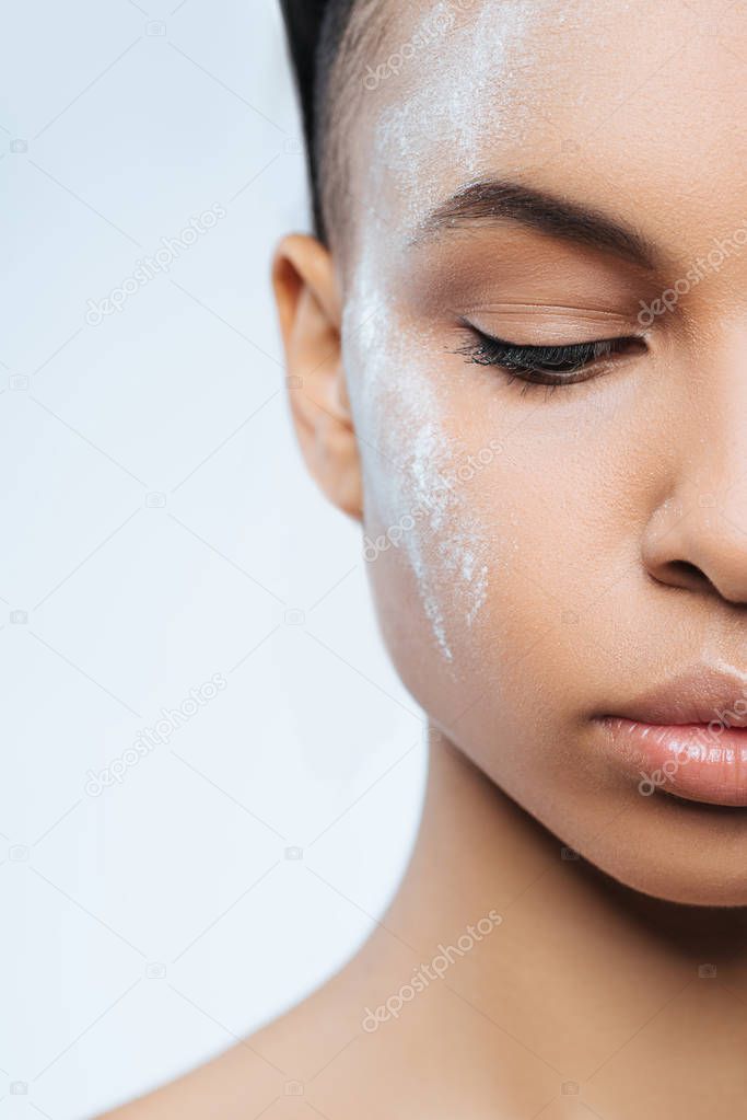 Attractive pleasant woman having white powder on her face