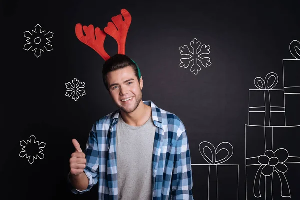 Happy charming man wearing Christmas accessory. — Stock Photo, Image