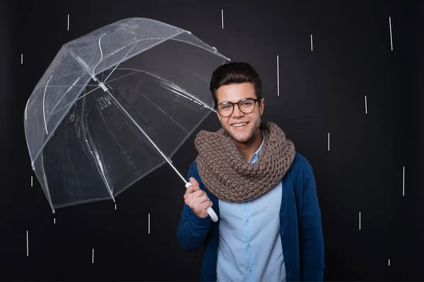Attractive joyful man holding an umbrella. — Stock Photo, Image