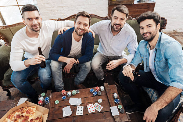 Positive cheerful men looking at you