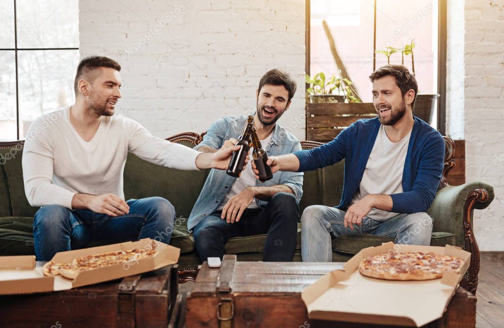 Nice happy friends cheering with beer