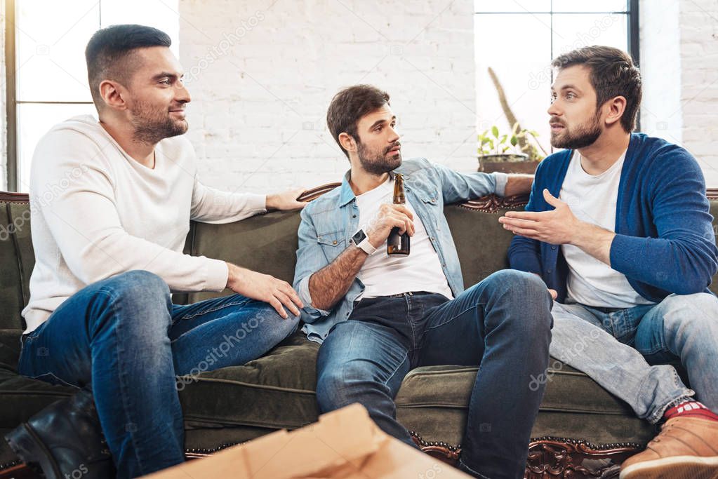 Pleasant young man looking at his friend