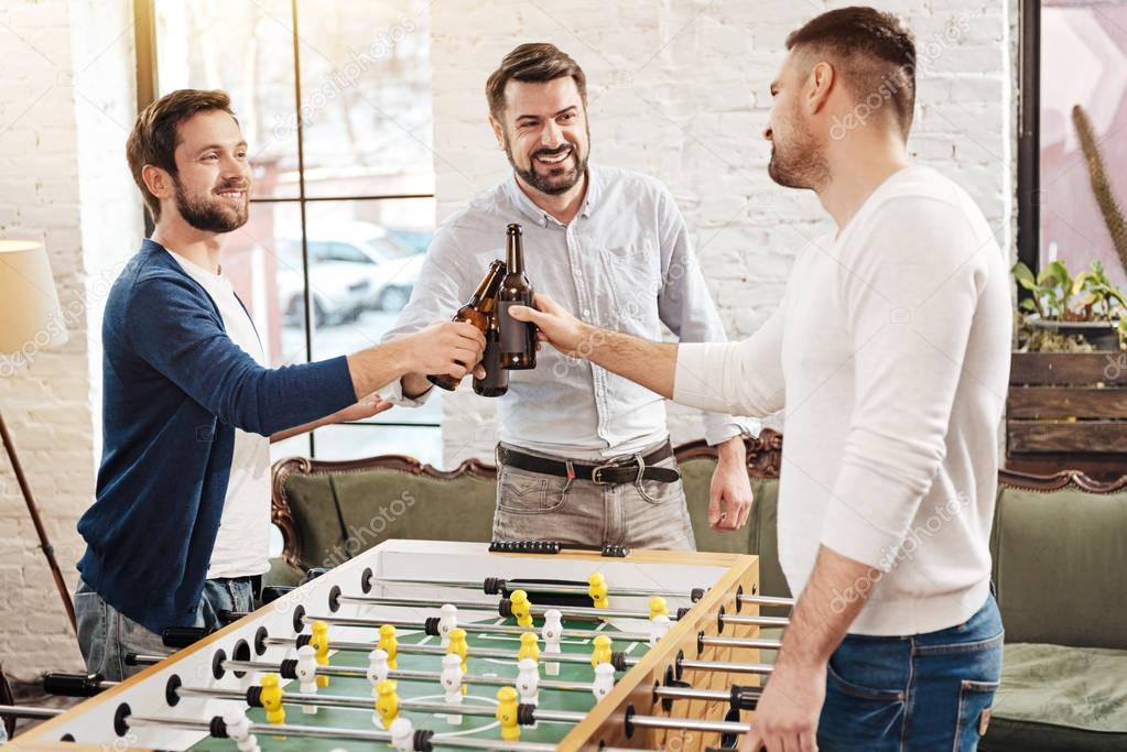 Positive male friends drinking beer