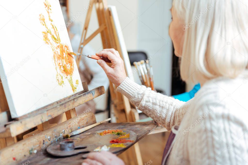 Creative woman painting in studio