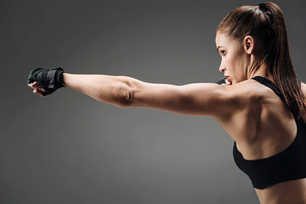 Active girl boxing on a grey background — Stock Photo, Image