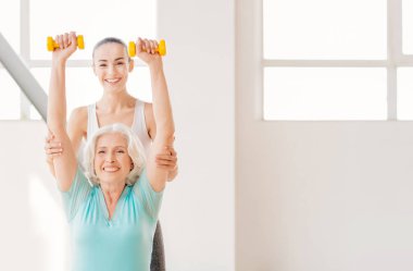 Pozitif genç çalıştırıcı arkasındaki kadın ayakta