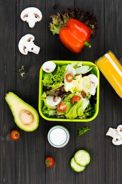 Red pepper lying on salad leaves — Stock Photo, Image