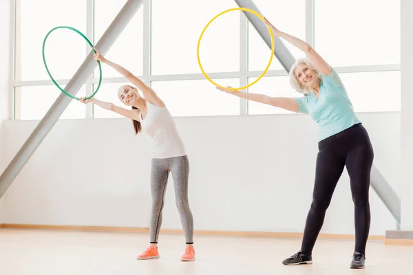 Bra snygg sportig kvinnor tränar med hula hoops — Stockfoto