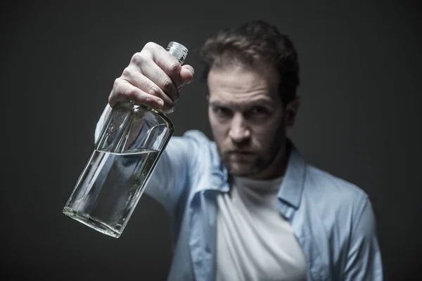 Close up of glass bottle being in male hands — Stock Photo, Image