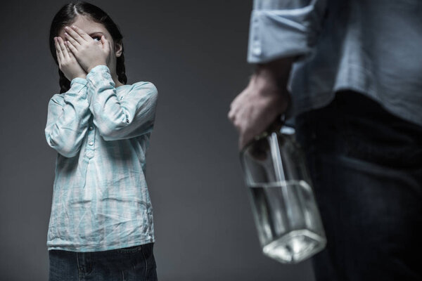 Very young girl spying on her drunk father