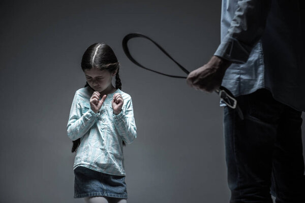 Very strict man holding belt in the fist