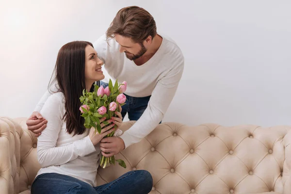 Handsome caring man giving a flower bouquet — Stock Photo, Image