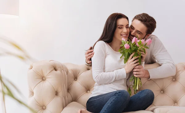 Happy beautiful woman holding flowers — Stock Photo, Image