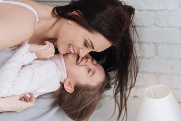 Delighted nice woman enjoying time with her daughter — Stock Photo, Image