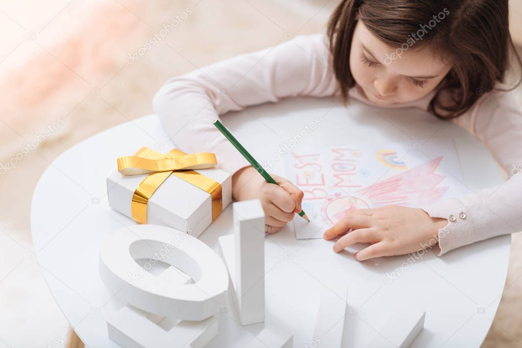 Cute creative girl focusing on drawing