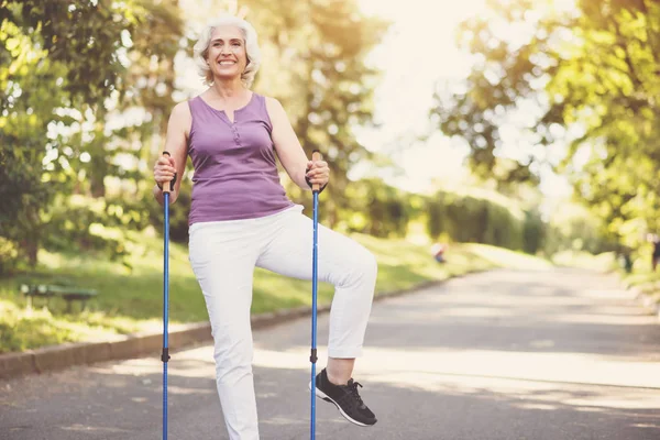 Mulher idosa alegre fazendo um exercício físico — Fotografia de Stock