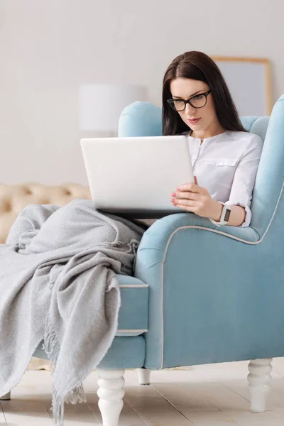 Pleasant brunette woman working at home