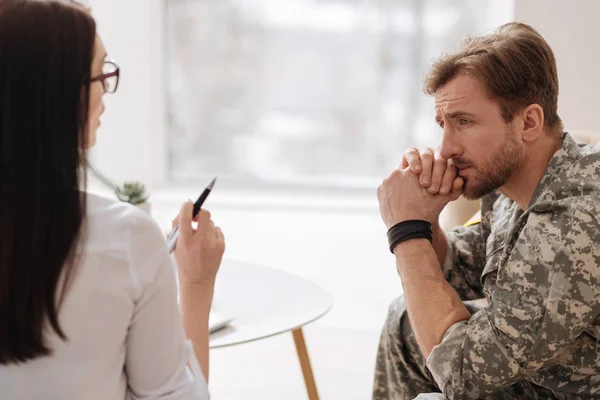 soldier listening attentively to psychologist