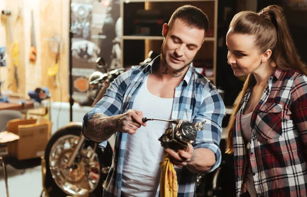 Positive delighted couple standing in the workshop — Stock Photo, Image