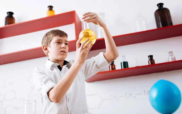 Boy pouring chemical reagent — Stock Photo, Image