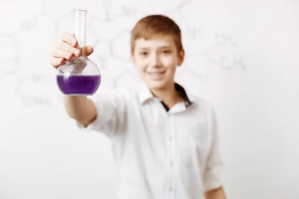 Boy pouring chemical reagent — Stock Photo, Image