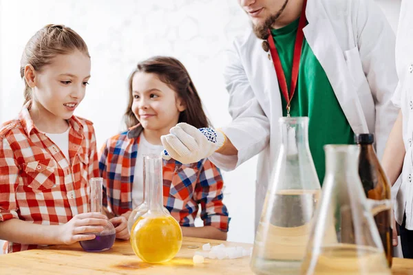 Girl looking at scientists hand — Stock Photo, Image