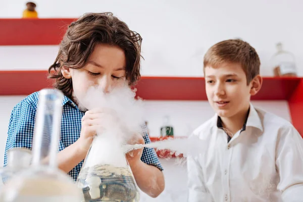 Boy holding chemical flask — Stock Photo, Image