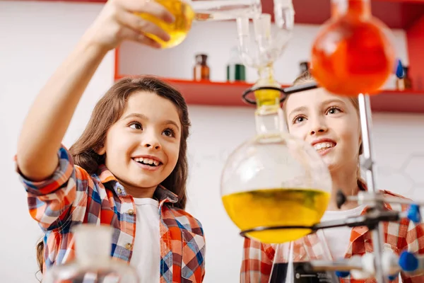 Girls holding chemical flasks — Stock Photo, Image