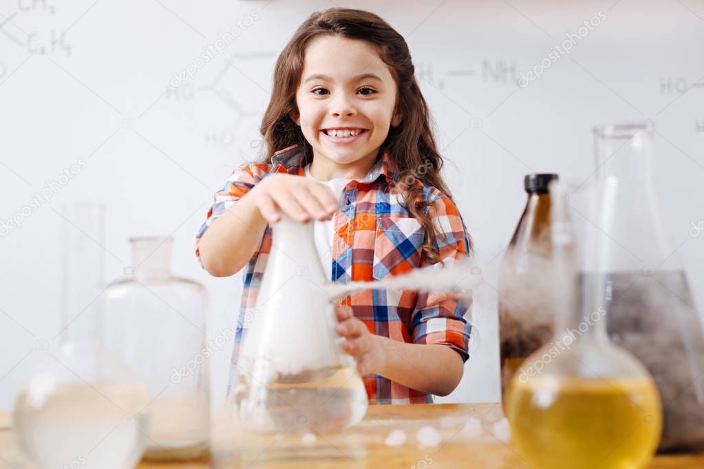 Girl putting hand on flask 