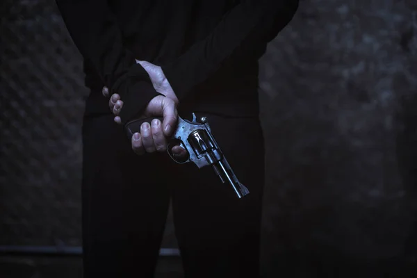 Man covering weapon behind back — Stock Photo, Image