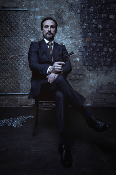 Brunette sitting in dark room