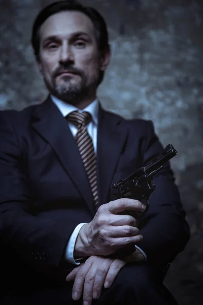 Businessman keeping pistol in hand — Stock Photo, Image