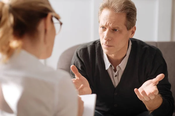 Unhappy man looking at therapist — Stock Photo, Image