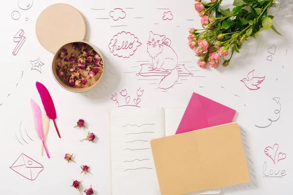 Notebook lying near flowers — Stock Photo, Image