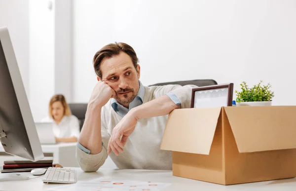 Melancholy fired office manager sitting in the office — Stock Photo, Image