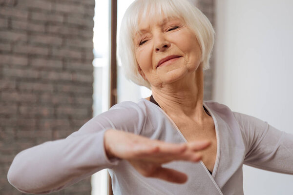 Elderly woman performing in ballroom 
