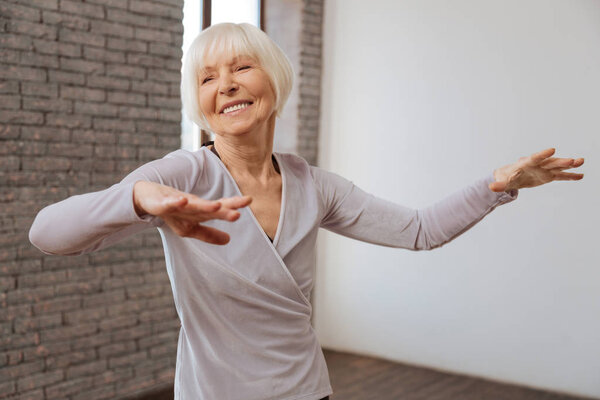 Aging woman performing in ballroom 
