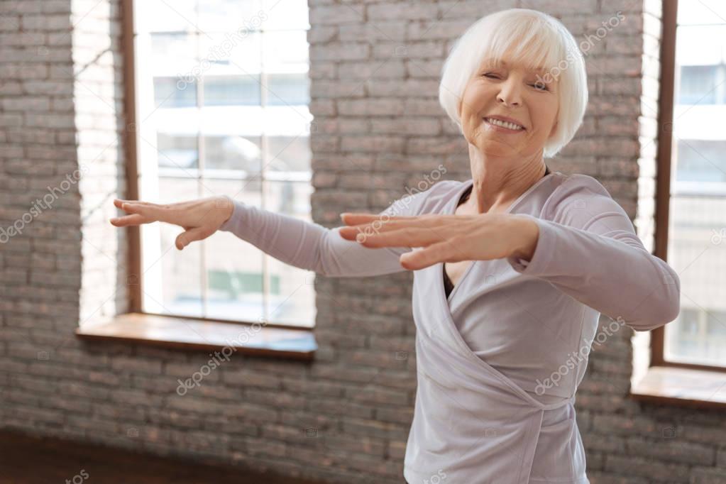 Elderly woman dancing in ballroom 