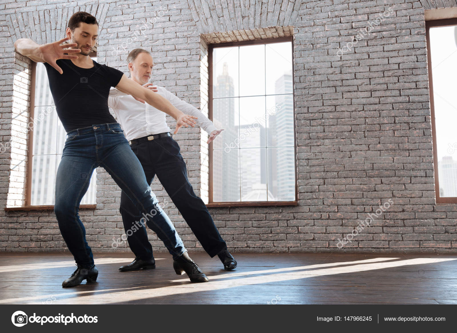 Charismatic dance couch teaching aging man tango at the ballroom — Stock Photo © yacobchuk1