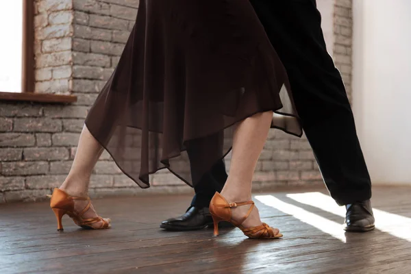 Talented aging couple waltzing in the ballroom — Stock Photo, Image