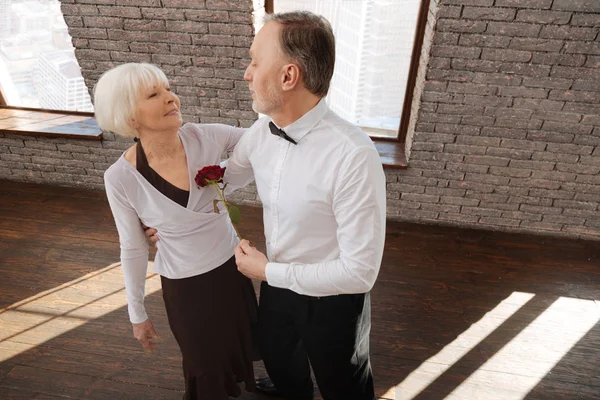 Passionate senior couple tangoing in the dance studio