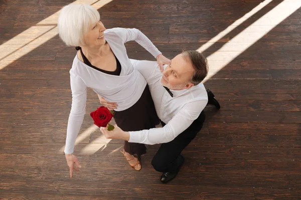 Levendige oude mens tangoing met zijn vrouw in de balzaal — Stockfoto