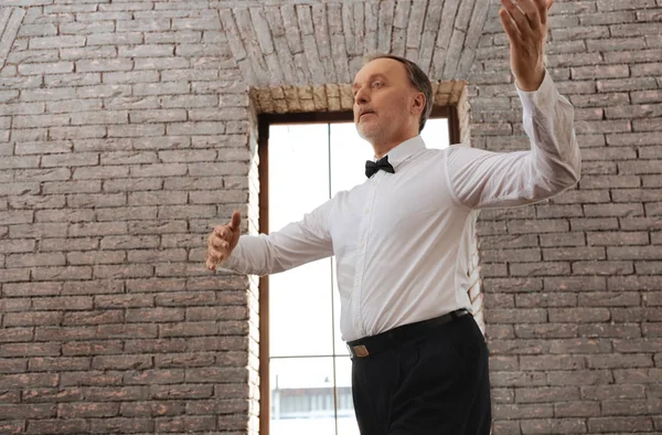 Hardworking charming pensioner learning waltz in the dance studio — Stock Photo, Image