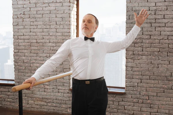 Graceful aged man performing in the art studio — Stock Photo, Image