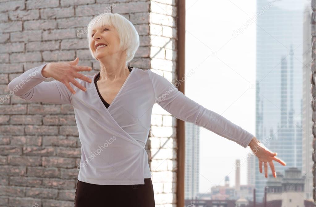 Positive aging woman mastering dance skills at the lesson
